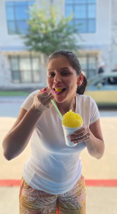A customer enjoying a Reignbow snoball outdoors